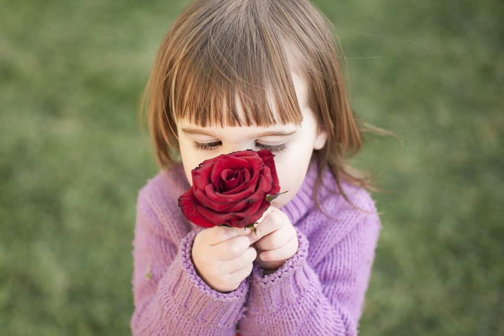 A girl smelling a rose