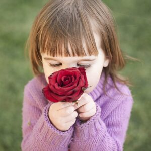 A girl smelling a rose